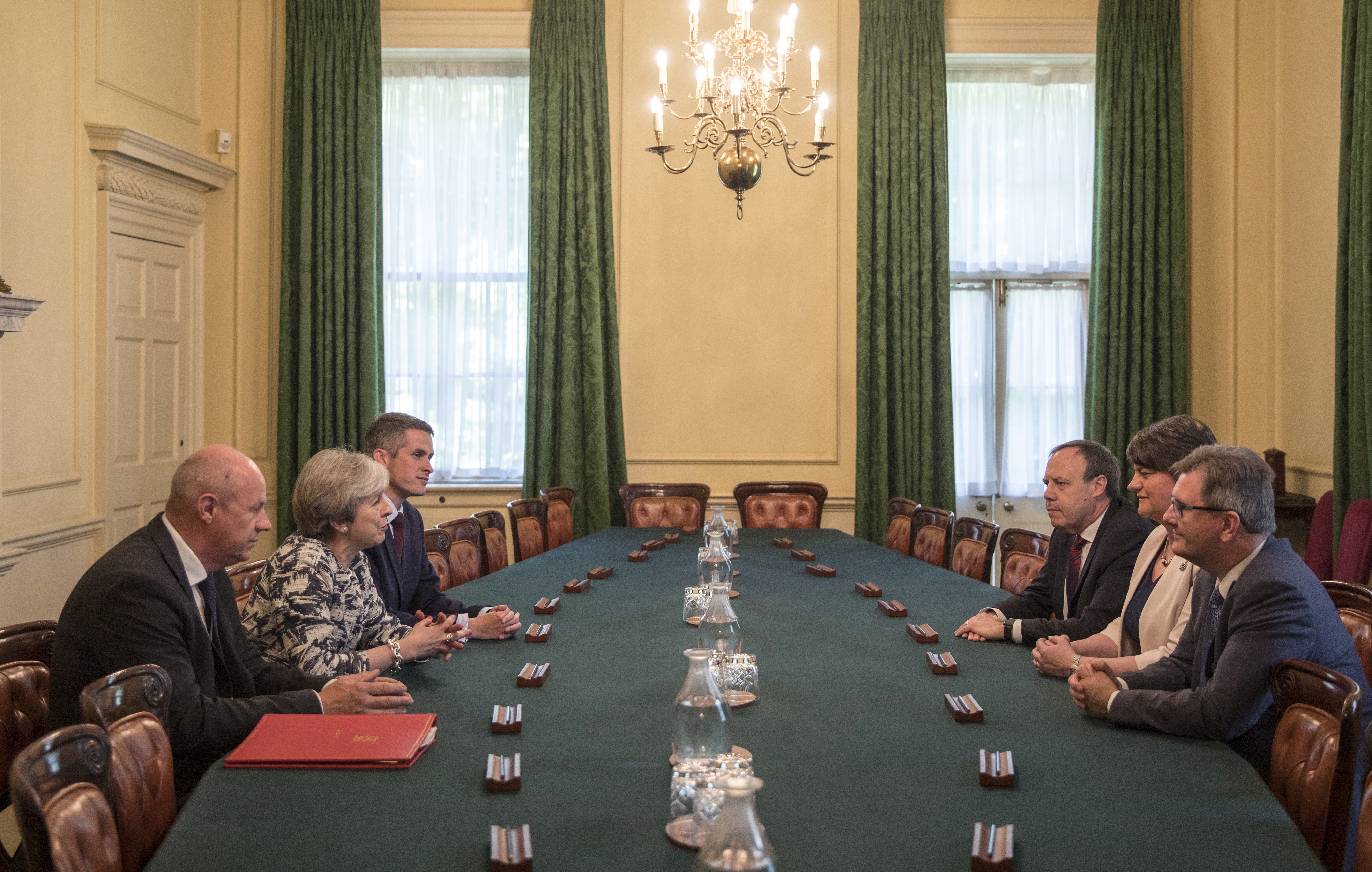 Britain's Prime Minister Theresa May, second left, sits with First Secretary of State Damian Green, left, and Government Chief Whip Gavin Williamson during their meeting with the Democratic Unionist Party (DUP) leader Arlene Foster, second right, DUP Deputy Leader Nigel Dodds, and DUP MP Jeffrey Donaldson, right, inside 10 Downing Street in central London, Monday June 26, 2017. Arlene Foster says that she struck a deal with Theresa May's Conservatives to support her minority government. (Jack Hill/Pool via AP)